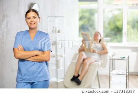 Young woman doctor posing in medical room Young woman doctor posing in medical room 137318387