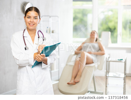 Young female doctor making notes in medical room Young female doctor making notes in medical room 137318456