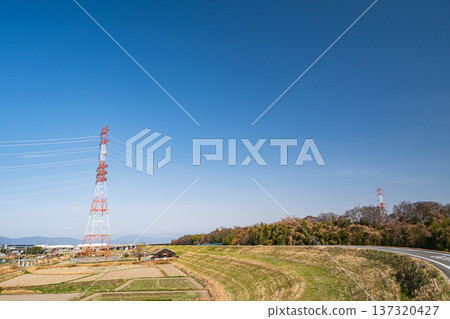 A steel tower standing in the countryside and a cycling road on the Kizu River embankment in Kyotanabe City, Kyoto Prefecture A steel tower standing in the countryside and a cycling road on the Kizu River embankment in Kyotanabe City, Kyoto Prefecture 137320427