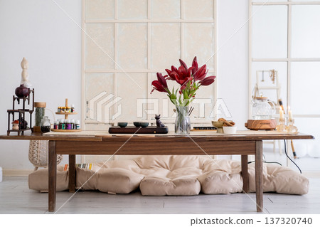 Dining room. Home atmosphere. Transparent teapot glass with tasty wholegrain snack candles bell for sound oil aromatherapy flower placed on table. 137320740