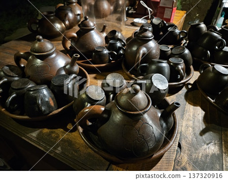This is a group of clay teapot with black colour 137320916