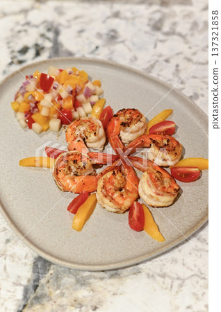 Appetizing grilled shrimp arranged beautifully on ceramic plate with fresh colorful fruit salad creating delightful and inviting seafood meal perfect for healthy dining experiences Appetizing grilled shrimp arranged beautifully on ceramic plate with fresh colorful fruit salad creating delightful and inviting seafood meal perfect for healthy dining experiences 137321858