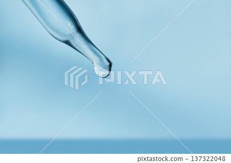 Pipette dripping single drop of liquid on light blue background 137322048