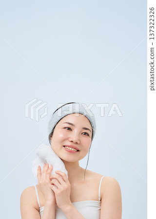 A woman wiping his face with a towel A woman wiping his face with a towel 137322326