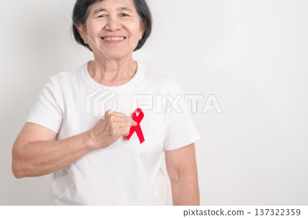 Elderly with Red Ribbon for December World Aids Day, MADD, October Red ribbon week, February Heart month, Marfan Syndrome, May Stroke awareness, March world TB Tuberculosis day and April Dare day Elderly with Red Ribbon for December World Aids Day, MADD, October Red ribbon week, February Heart month, Marfan Syndrome, May Stroke awareness, March world TB Tuberculosis day and April Dare day 137322359