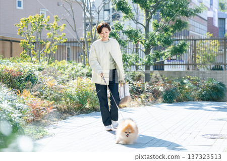 Lifestyle: A woman walking her dog 137323513