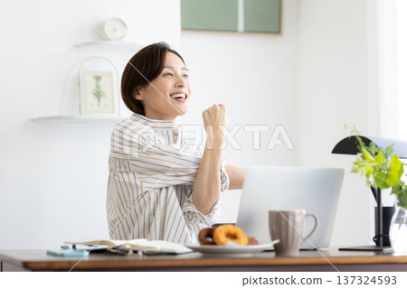 Telework: A woman working from home 137324593