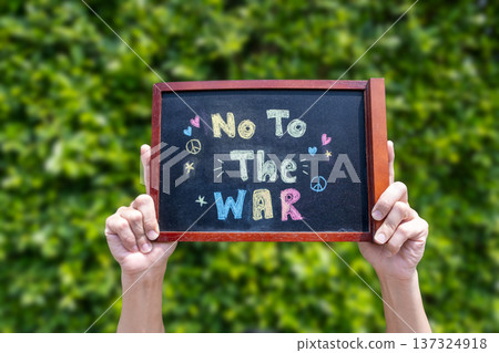 Hands Holding No To The War Chalkboard Sign Outdoors Hands Holding No To The War Chalkboard Sign Outdoors 137324918