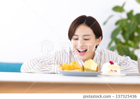 A woman choosing a cake A woman choosing a cake 137325436
