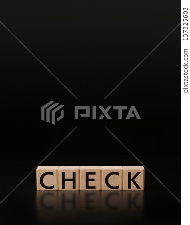 Wooden building blocks "CHECK" letters on a black matte background, vertical composition, copy space Wooden building blocks "CHECK" letters on a black matte background, vertical composition, copy space 137325603