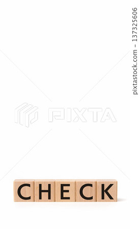 Wooden building blocks "CHECK" letters on a white matte background, vertical composition, copy space Wooden building blocks "CHECK" letters on a white matte background, vertical composition, copy space 137325606