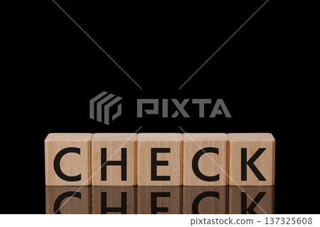 Wooden building blocks "CHECK" letters on a black glossy background, copy space 137325608