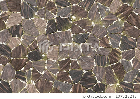 Dark brown irregular stone masonry wall texture 137326283