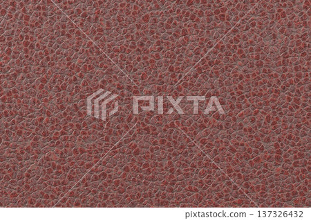 Rough red cracked earth or dry ground texture with dark crevices and uneven surface. 137326432