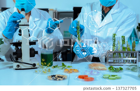 Eco laboratory microbiology. Sample in a Microscope and comparing a plant or herb in test tube or glassware. Natural product and organic cosmetic health care. Eco laboratory microbiology. Sample in a Microscope and comparing a plant or herb in test tube or glassware. Natural product and organic cosmetic health care. 137327705