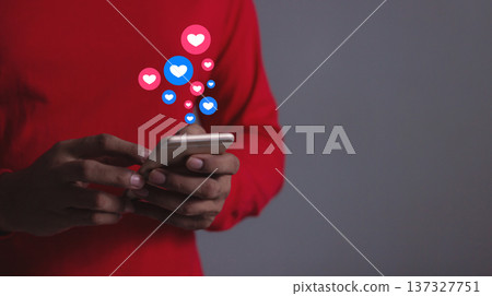 Love And Like Social Media Concept, Young Man hand using smart phone mobile, with Social Media, on soft blurred background Love And Like Social Media Concept, Young Man hand using smart phone mobile, with Social Media, on soft blurred background 137327751