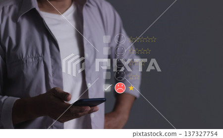 Customer Review, Young man hand holding smartphone to review and gives 1 star, with poor service results, Bad review Rated just 1 star Feedback options 137327754