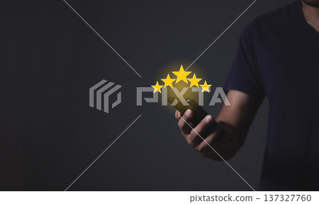 Review Customer, Young Man hand holding Smart Phone with five star to review and give 5 stars with very good results in service, Good review 5 star rating choice feedback Review Customer, Young Man hand holding Smart Phone with five star to review and give 5 stars with very good results in service, Good review 5 star rating choice feedback 137327760