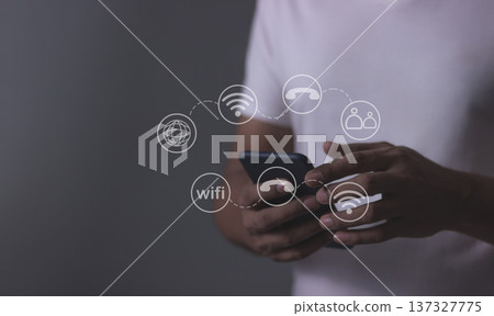 Young man hand using smartphone with to Interconnect, Interconnected Concept; People connect via wireless internet in a world of digital technology and communications that connect 137327775
