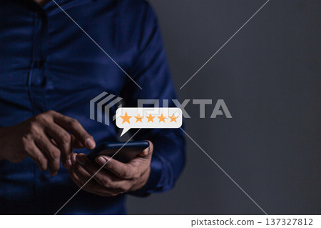 Customer Review, Young Man hand holding Smart Phone with five star to review and give 5 stars with very good results in service, Good review 5 star rating choice feedback Customer Review, Young Man hand holding Smart Phone with five star to review and give 5 stars with very good results in service, Good review 5 star rating choice feedback 137327812