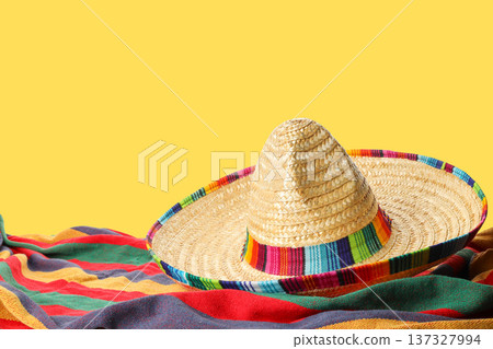 Cinco de Mayo, A sombrero awaits on colorful fabric Cinco de Mayo, A sombrero awaits on colorful fabric 137327994