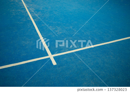 Padel court surface with blue color and white lines 137328023
