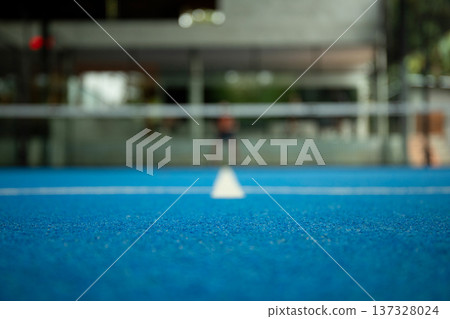 Padel sport court with blue surface under bright lights 137328024