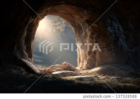 Sunlight pierces a dark cave entrance. Golden rays illuminate rocky textures inside. Shadowed walls frame the glowing opening. Dappled light touches the cave floor 137328588