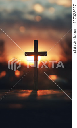 Silhouetted cross stands against setting sun. Warm glow bathes the scene in golden hues. Soft bokeh adds dreamlike depth to background. Still water reflects the cross's dark outline Silhouetted cross stands against setting sun. Warm glow bathes the scene in golden hues. Soft bokeh adds dreamlike depth to background. Still water reflects the cross's dark outline 137328627