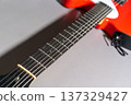 Red Guitar Neck Close-Up 137329427