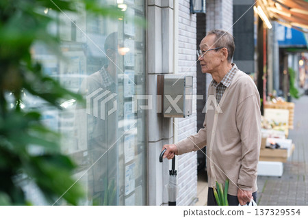 Senior man searching for property in real estate Senior man searching for property in real estate 137329554