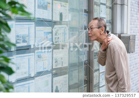 Senior man searching for property in real estate Senior man searching for property in real estate 137329557