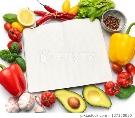 Open recipe book surrounded by fresh vegetables ingredients Open recipe book surrounded by fresh vegetables ingredients 137330030