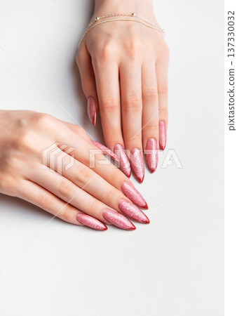 Woman hands manicure with long glittery rose gold nails Woman hands manicure with long glittery rose gold nails 137330032