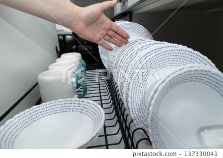 Organized Kitchen Drying Rack With Clean Dishes and Mugs Ready for Use After Washing Organized Kitchen Drying Rack With Clean Dishes and Mugs Ready for Use After Washing 137330041