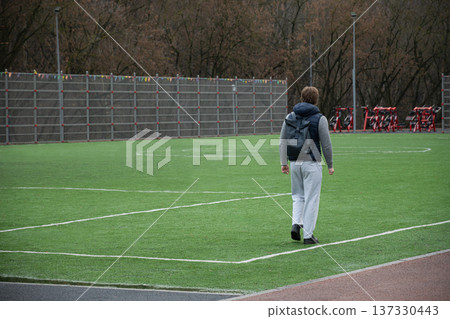 Man Lifting Dumbbell in Outdoor Gym Setting 137330443