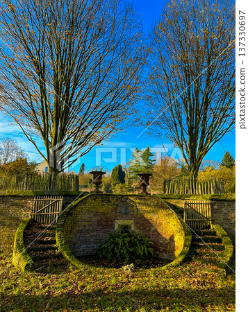 Vintage bronze vases on beautiful circular platform in park under clear blue sky Vintage bronze vases on beautiful circular platform in park under clear blue sky 137330697