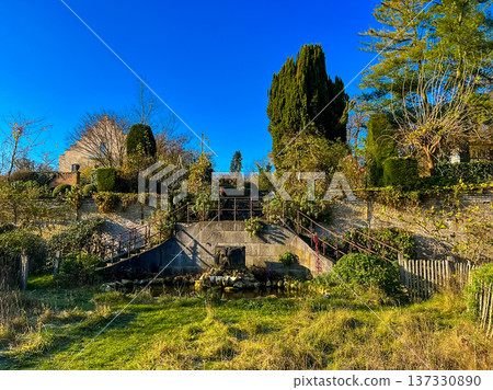 A scenic view of an abandoned hillside with blue sky and old garden A scenic view of an abandoned hillside with blue sky and old garden 137330890