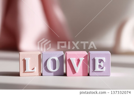 Love word made of pastel wooden blocks with soft romantic lighting Love word made of pastel wooden blocks with soft romantic lighting 137332074
