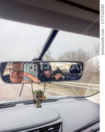 Family selfie reflected in car rearview mirror Family selfie reflected in car rearview mirror 137332086
