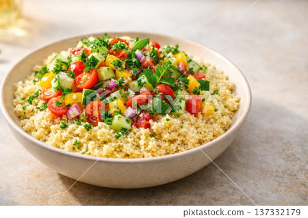 Fresh healthy couscous salad with vegetables herbs and tomatoes in bowl Fresh healthy couscous salad with vegetables herbs and tomatoes in bowl 137332179