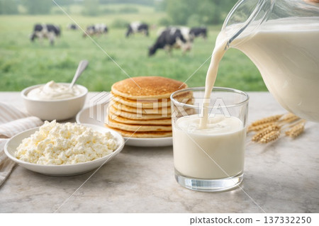 Fresh milk pouring into glass with pancakes and cottage cheese on farm background 137332250