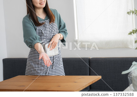 Woman showing customers to their table (no face) Woman showing customers to their table (no face) 137332588