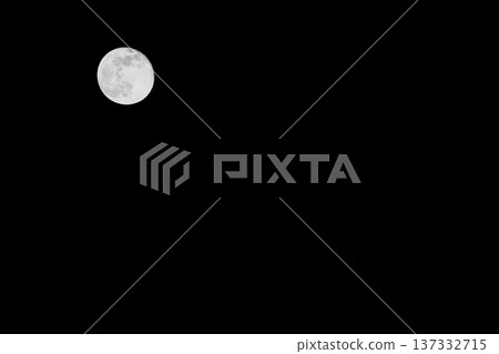 Full moon floating in the night sky 137332715