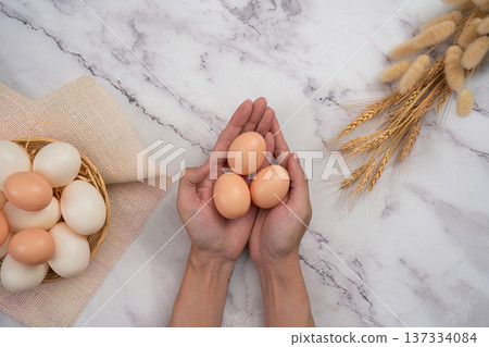 SSTK Easter. Fresh eggs in hands for festive cooking. 137334084