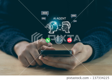 Hands holding smartphone with AI agent hologram interface. Artificial intelligence chatbot and virtual assistant communication concept. 137334225