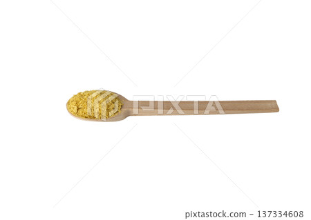Savoury vegan yeast flakes on wooden spoon isolated on white background. Savoury vegan yeast flakes on wooden spoon isolated on white background. 137334608