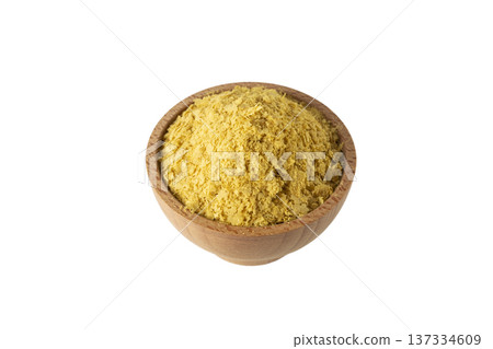 Savoury vegan yeast flakes in wooden bowl isolated on white background. Savoury vegan yeast flakes in wooden bowl isolated on white background. 137334609