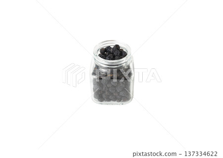 Dried Aronia or black chokeberry - Aronia melanocarpa in latin in a glass jar isolated on white background. Dried Aronia or black chokeberry - Aronia melanocarpa in latin in a glass jar isolated on white background. 137334622