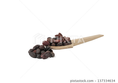 Dogwood or Cornel fruit herb used in herbal medicine on wooden spoon isolated on white background. Herbs. Alternative medicine. Dogwood or Cornel fruit herb used in herbal medicine on wooden spoon isolated on white background. Herbs. Alternative medicine. 137334634